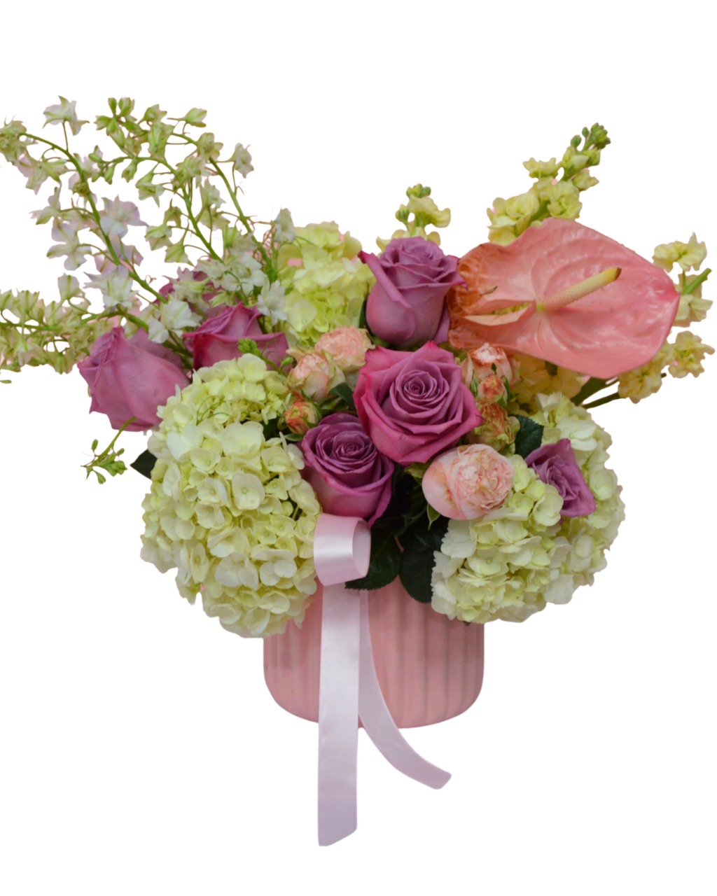Bouquet of flowers with pink roses, hydrangeas, and anthurium in a pink container on a white background