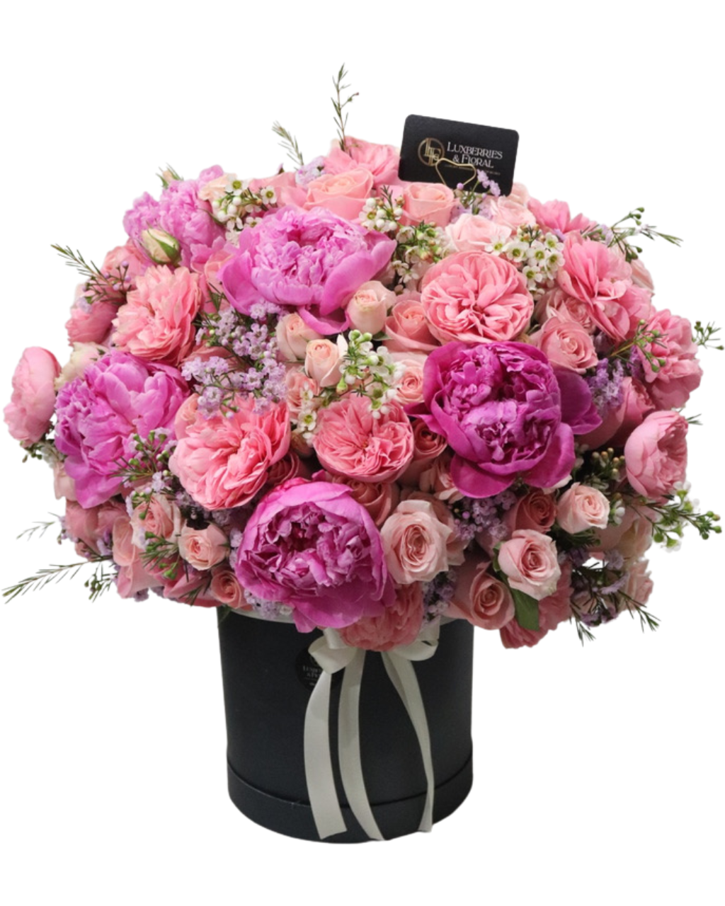 Bouquet of pink and purple flowers in a black box with a visible brand label.