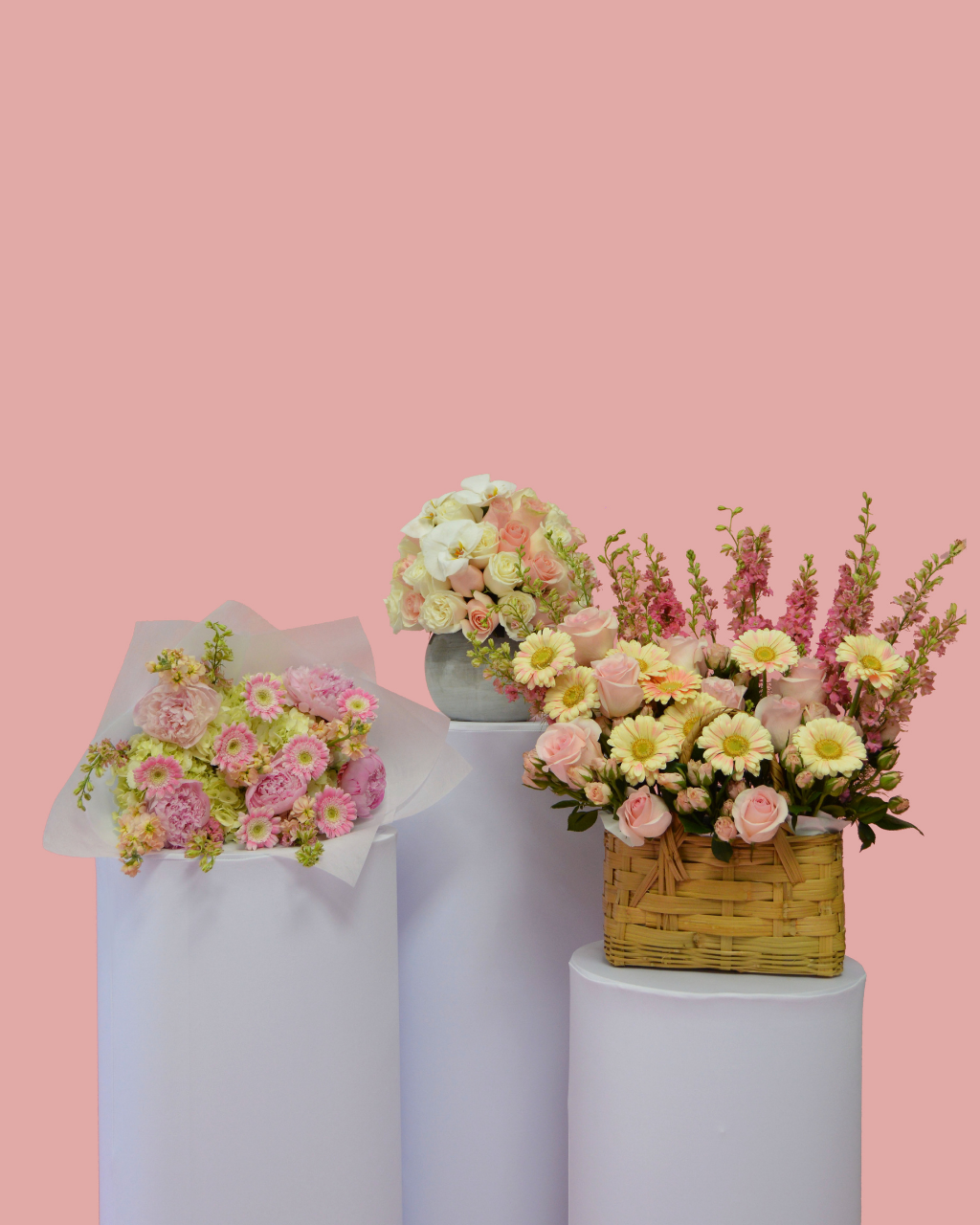 Floral arrangement in a woven basket on a white background