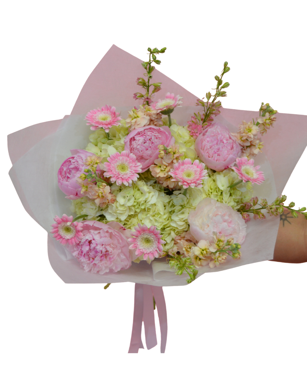 Bouquet of pink and green flowers wrapped in white paper with a pink ribbon on a white background