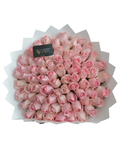 Bouquet of pink roses with a visible brand label on a white background