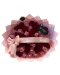 Bouquet of red and pink roses with a pink bow and transparent wrapping paper on a white background.