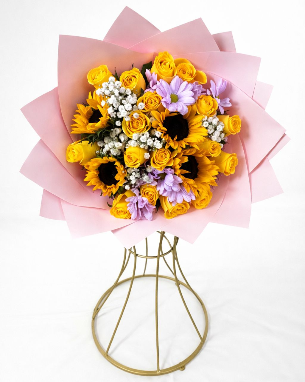 Bouquet of yellow and purple flowers with a gold wire basket on a white background