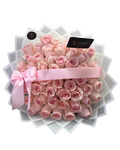 Bouquet of pink roses with a pink ribbon on a white stand, branded 'Luxberries Floral'.