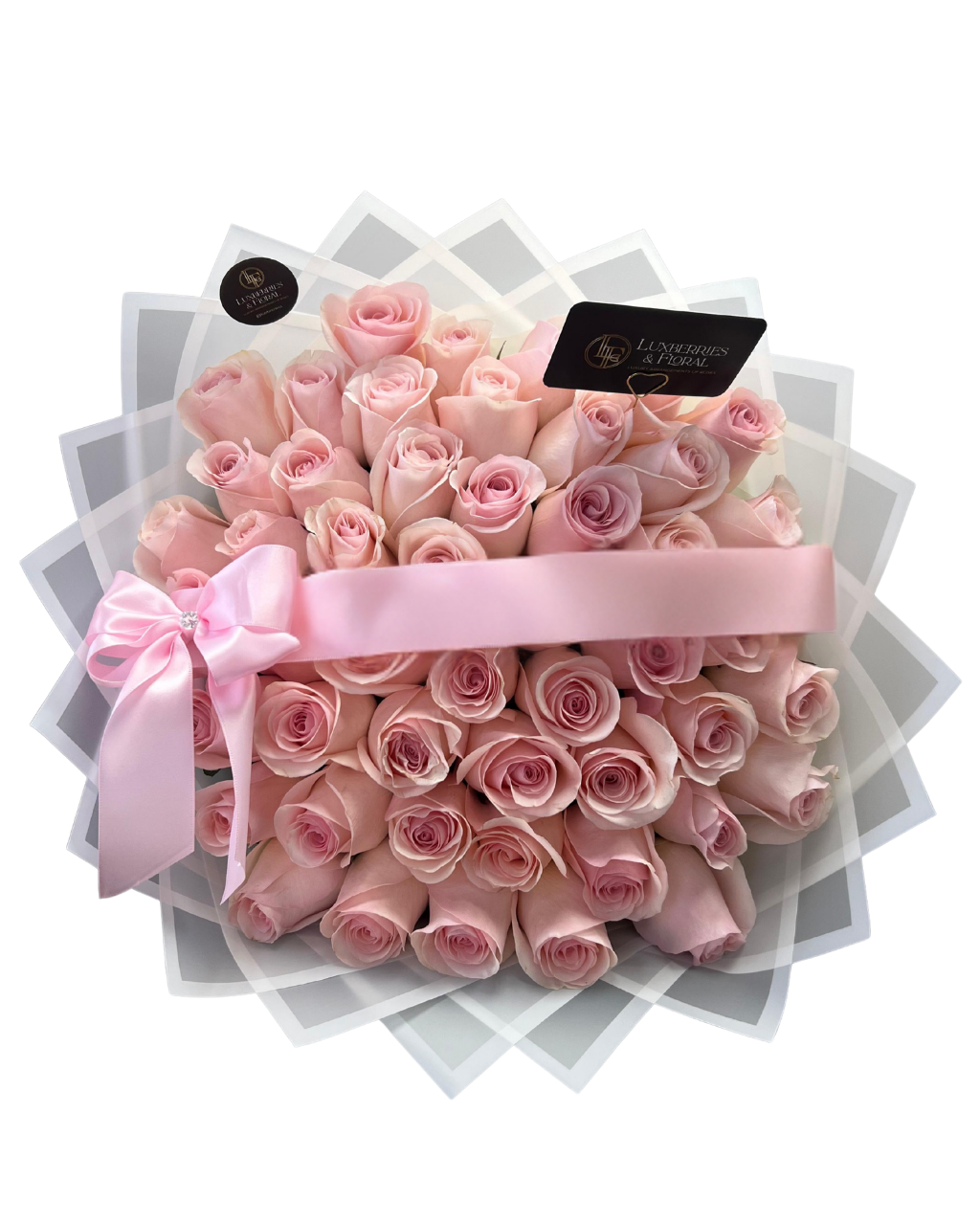 Bouquet of pink roses with a pink ribbon on a white stand, branded 'Luxberries Floral'.