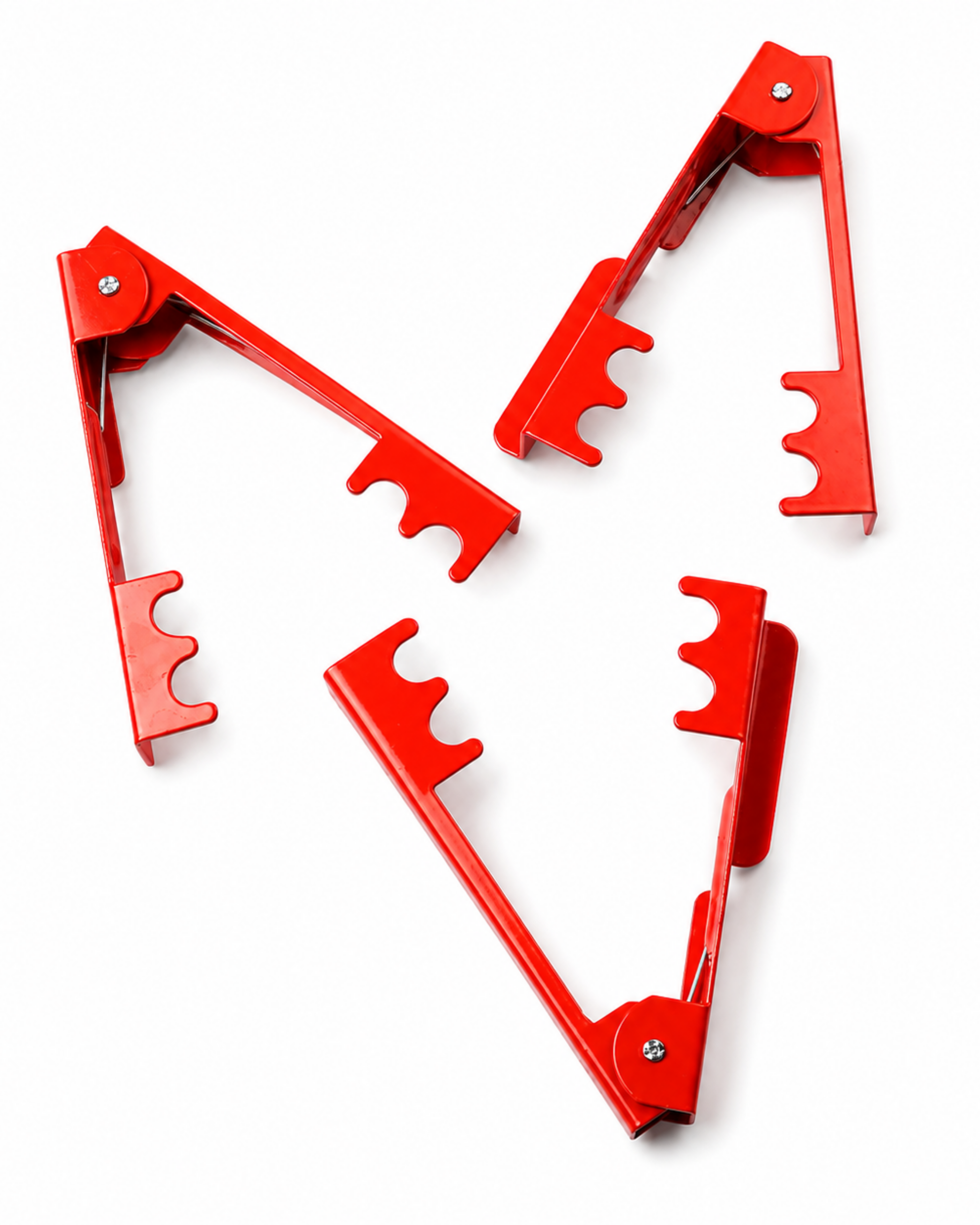 Three red metal folding tool pieces arranged on a plain white background.