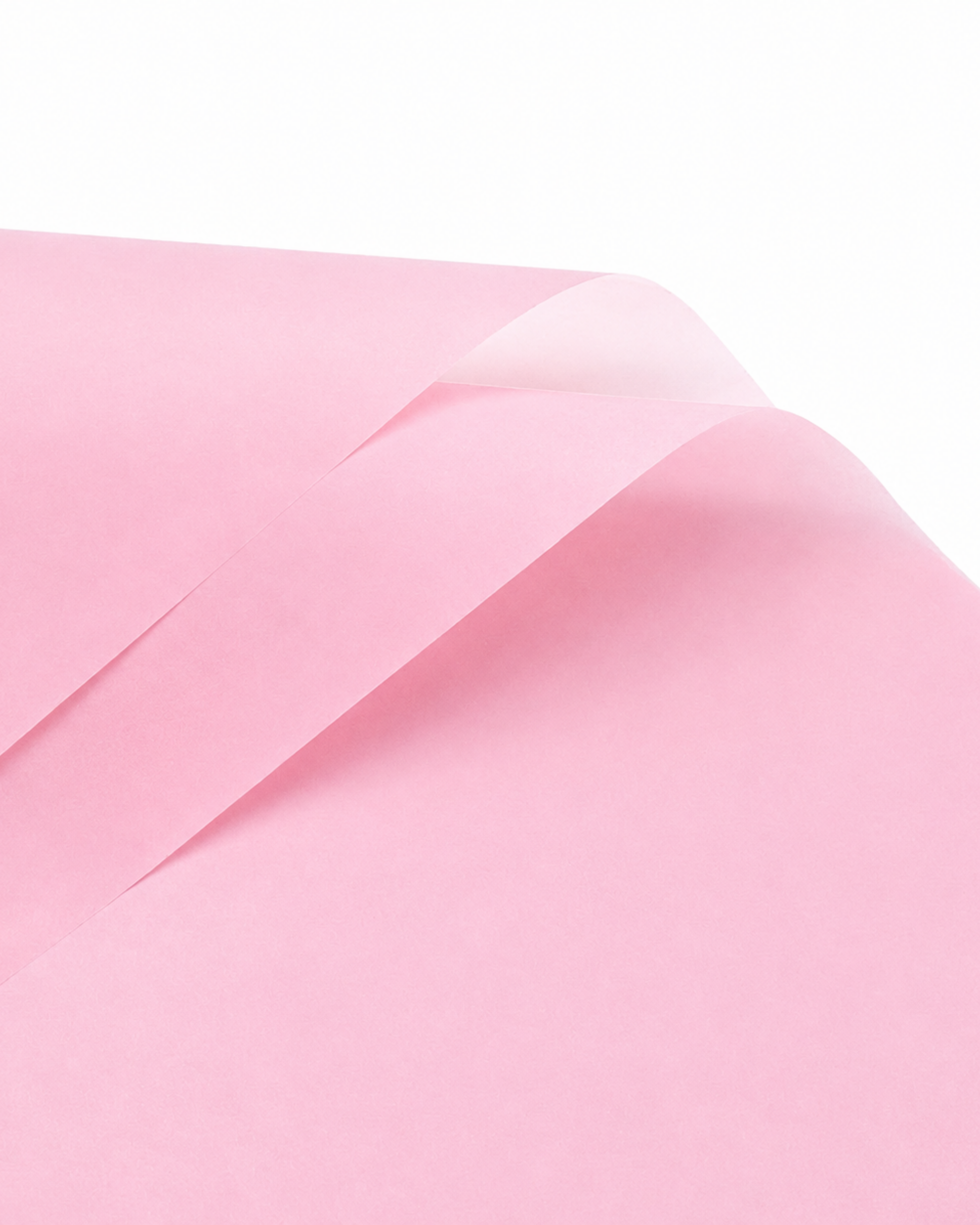 A close-up of a light pink sheet of paper with soft folds and a slightly translucent quality, set against a clean white background.