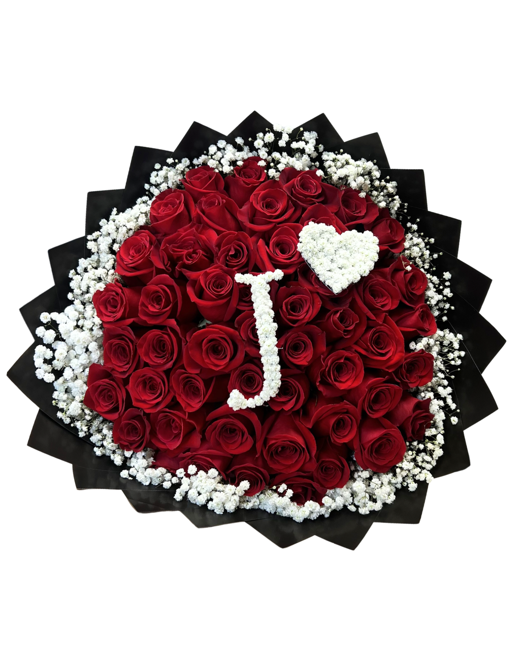 A heart-shaped bouquet of deep red roses wrapped in black paper, decorated with white baby's breath and a white pearl monogram letter 'J' shaped like a heart.