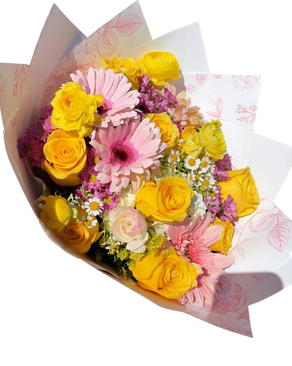 A vibrant bouquet of yellow and pink flowers, including roses and gerbera daisies, wrapped in white paper with a pink floral pattern, set against a solid white background.